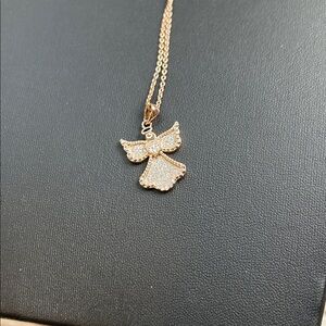 JCM rose gold-tone angel pendant necklace with pavé-set white CZ stones.
